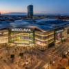 Best shopping malls in Wrocław with a modern shopping center and city skyline at dusk