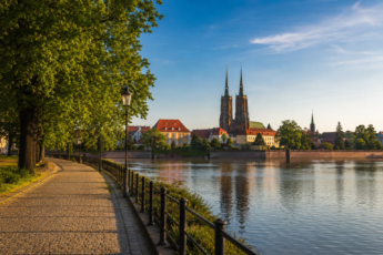Scenic walking route along the Oder River in Wrocław with cathedral views at sunset