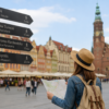 Tourist checking a city map on Wrocław Market Square in Poland