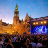 Crowd at an outdoor music festival in Wrocław Market Square during an evening concert