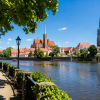 Shaded riverside promenade in Wrocław during a hot summer day near Ostrów Tumski